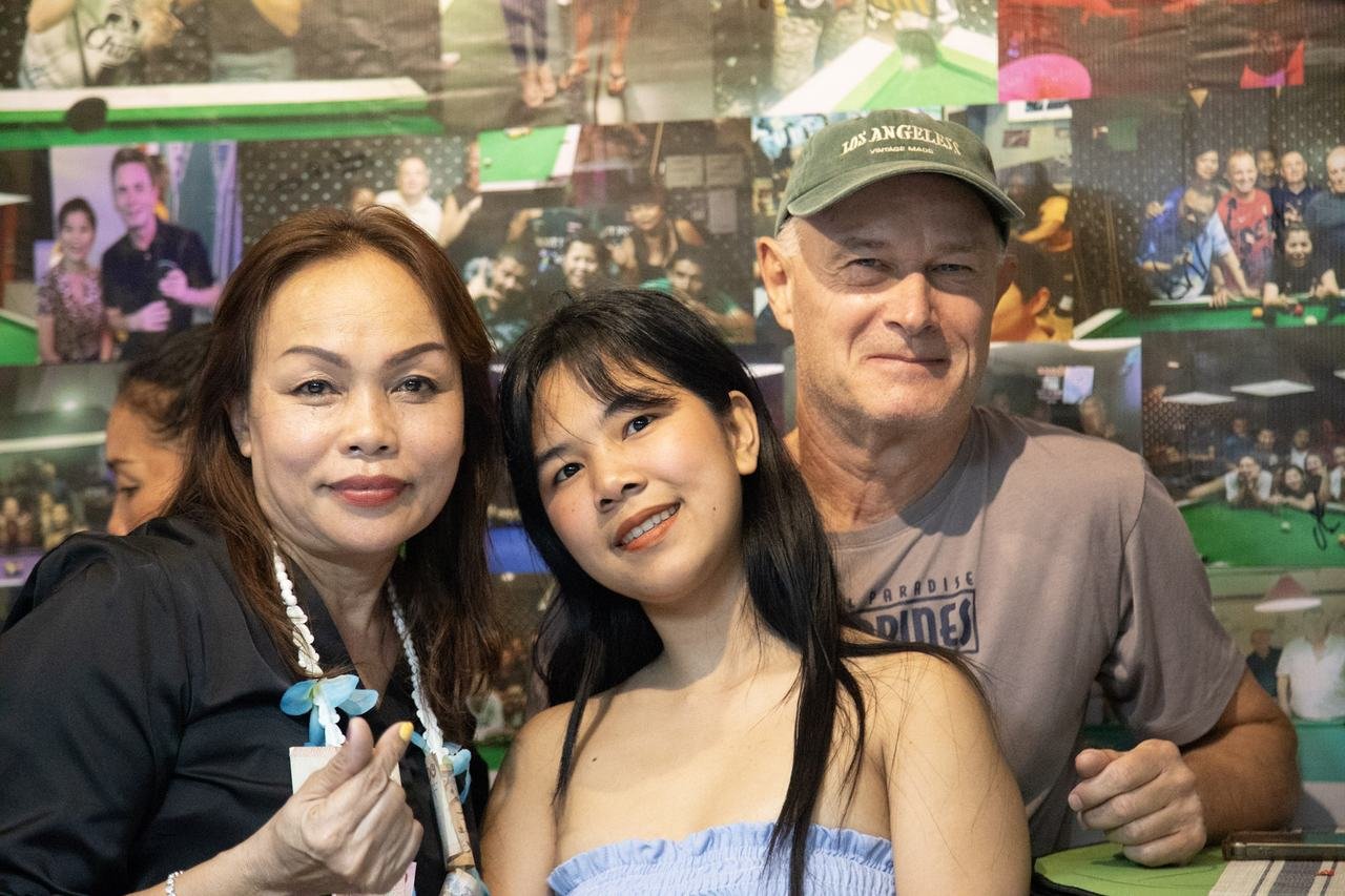 A relaxed group portrait in front of the bar's photo wall