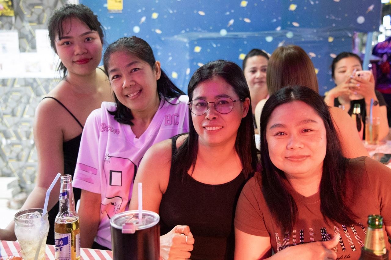 Five friends huddled together under a starry wall