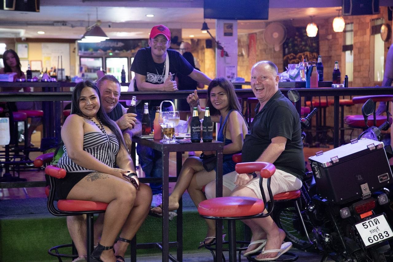 Friends gathered around the table for drinks and laughter