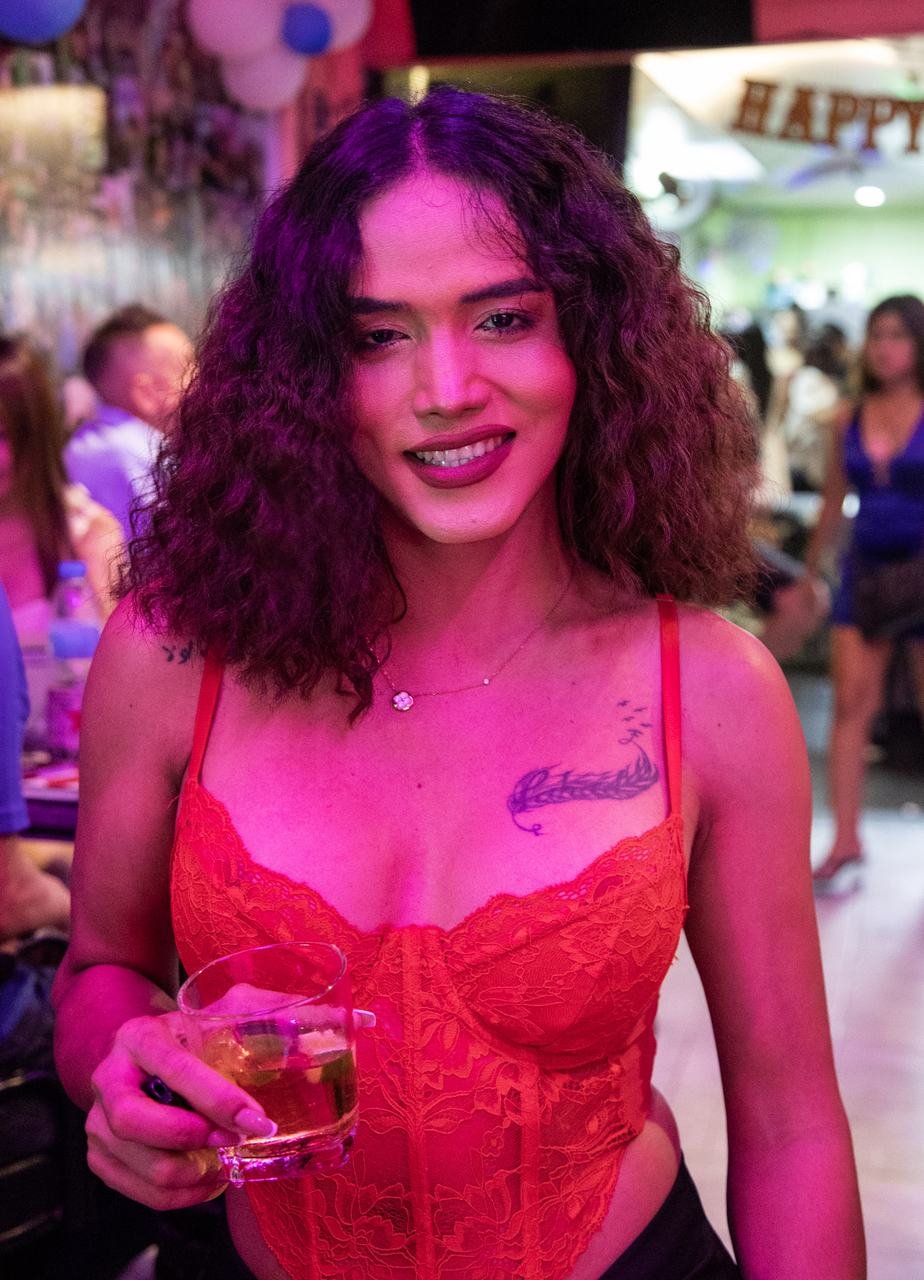 Raising a drink under the glow of the party lights